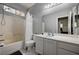 Bathroom featuring a tub with shower, toilet, vanity with mirror, and stained glass window at 6538 Astorville Ct, Las Vegas, NV 89110