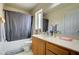 Bathroom showcases a white vanity countertop and tub with gray shower curtain at 6538 Astorville Ct, Las Vegas, NV 89110