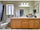 Bathroom featuring a wooden vanity, large mirror, and shower with tub at 6538 Astorville Ct, Las Vegas, NV 89110
