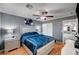 Bedroom with gray walls, wood floors, a ceiling fan, and modern decor elements at 6538 Astorville Ct, Las Vegas, NV 89110