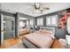 Bedroom featuring dark gray walls, wood floors, a ceiling fan, and modern decor at 6538 Astorville Ct, Las Vegas, NV 89110