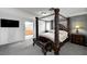 Bedroom showcasing an elegant four-poster bed, neutral tones, and a glimpse into the bathroom at 6538 Astorville Ct, Las Vegas, NV 89110