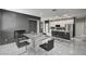 Modern dining room with marble floors, modern table, and open-concept kitchen at 6538 Astorville Ct, Las Vegas, NV 89110