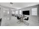 Bright dining area with marble floors, modern table, and expansive open layout at 6538 Astorville Ct, Las Vegas, NV 89110