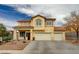 Two-story home featuring a red tile roof, stucco exterior, and a spacious three-car garage at 6538 Astorville Ct, Las Vegas, NV 89110