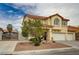 Two-story stucco home with red tile roof, desert landscaping, and a three-car garage at 6538 Astorville Ct, Las Vegas, NV 89110