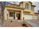 Close-up of home's front entrance showing stucco exterior and three car garage at 6538 Astorville Ct, Las Vegas, NV 89110