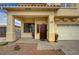 A view of a home's front entrance including a three-car garage and desert landscaping at 6538 Astorville Ct, Las Vegas, NV 89110