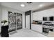 Stylish kitchen featuring white cabinets, stainless steel appliances, and sliding glass door at 6538 Astorville Ct, Las Vegas, NV 89110