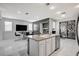 Bright kitchen featuring an island with a sink, modern appliances, and decorative sliding-glass doors at 6538 Astorville Ct, Las Vegas, NV 89110