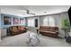 Second floor living room area with carpet, ceiling fan, sofas, a glass table, and wall art at 6538 Astorville Ct, Las Vegas, NV 89110