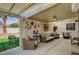 Inviting covered patio with comfortable seating, ceiling fan, and decorative accents at 6538 Astorville Ct, Las Vegas, NV 89110