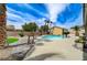 Lush backyard with a pristine pool, stone walkway, and tropical landscaping creating a private retreat at 6971 Moaning Cavern St, Las Vegas, NV 89131