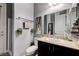 A well-lit bathroom features a dark wood vanity, a shower with glass doors, and decorative accents at 6971 Moaning Cavern St, Las Vegas, NV 89131