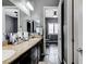 Bathroom with double sinks, cabinets and a view of the bedroom area at 6971 Moaning Cavern St, Las Vegas, NV 89131