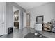 Bedroom area with a salon chair, gray walls, and access to the bathroom at 6971 Moaning Cavern St, Las Vegas, NV 89131