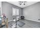 Bedroom area with a chair, window, and gray walls, and a ceiling fan at 6971 Moaning Cavern St, Las Vegas, NV 89131