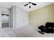 Bedroom featuring plush carpeting, a large closet, and access to a connected room with tile flooring at 6971 Moaning Cavern St, Las Vegas, NV 89131