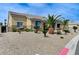 Single story home features desert landscaping with multiple palm trees at 6971 Moaning Cavern St, Las Vegas, NV 89131