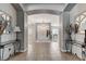 Spacious foyer with arched doorways, tile flooring, and decorative console tables at 6971 Moaning Cavern St, Las Vegas, NV 89131
