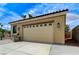 A detached garage with a large door and grill, showcasing additional parking and potential workshop space at 6971 Moaning Cavern St, Las Vegas, NV 89131