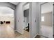 Hallway with tiled floors, arched entryway, and views of the bathroom and bedroom for easy access at 6971 Moaning Cavern St, Las Vegas, NV 89131