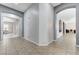 Spacious hallway with tile flooring and arched doorways, offering a view into multiple rooms at 6971 Moaning Cavern St, Las Vegas, NV 89131