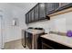 Laundry room featuring modern washer and dryer and overhead cabinets at 6971 Moaning Cavern St, Las Vegas, NV 89131