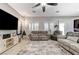 Bright living room featuring tiled floors, ceiling fan, entertainment center and comfortable seating at 6971 Moaning Cavern St, Las Vegas, NV 89131