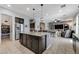Spacious open-concept kitchen and living area with granite counters and stainless steel appliances at 6971 Moaning Cavern St, Las Vegas, NV 89131