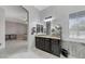 Open-concept bathroom with a vanity, a mirror, and a partial view of the bedroom at 6971 Moaning Cavern St, Las Vegas, NV 89131