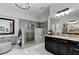 Elegant bathroom showcasing a spacious tiled shower, dual sinks, and stylish fixtures at 6971 Moaning Cavern St, Las Vegas, NV 89131