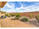 Relaxing brick patio backyard with outdoor seating, lush greenery, and mountain views at 7264 Summer Duck Way, North Las Vegas, NV 89084