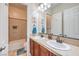 Bathroom featuring double sinks, a tiled shower and tub combo, and ample cabinet space at 7264 Summer Duck Way, North Las Vegas, NV 89084