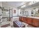 Bright bathroom featuring double sinks, a soaking tub, and a glass-enclosed shower at 7264 Summer Duck Way, North Las Vegas, NV 89084