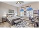 Bedroom with queen bed, hardwood floors, a ceiling fan, and an attached desk setup at 7264 Summer Duck Way, North Las Vegas, NV 89084