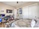 Comfortable bedroom features a TV, desk, and closet for storage and relaxation at 7264 Summer Duck Way, North Las Vegas, NV 89084
