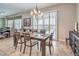 A dining room with a six place dining table and sliding glass doors for natural light at 7264 Summer Duck Way, North Las Vegas, NV 89084