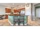 A kitchen featuring dark wood cabinets, stainless steel appliances, and a breakfast bar with seating at 7264 Summer Duck Way, North Las Vegas, NV 89084