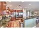 A well-equipped kitchen with dark wood cabinets, stainless steel appliances, and granite countertops at 7264 Summer Duck Way, North Las Vegas, NV 89084
