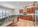A kitchen featuring stainless steel appliances, dark wood cabinetry, and a breakfast bar with a sink at 7264 Summer Duck Way, North Las Vegas, NV 89084