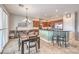 A kitchen and dining area featuring dark wood cabinets, granite countertops, and a stylish chandelier at 7264 Summer Duck Way, North Las Vegas, NV 89084