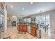 An open concept kitchen and living area with a breakfast bar, stainless steel appliances, and fireplace at 7264 Summer Duck Way, North Las Vegas, NV 89084