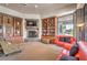 Inviting living room featuring built-in bookshelves, a cozy fireplace, and an oversized window with natural light at 7264 Summer Duck Way, North Las Vegas, NV 89084