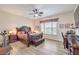 A spacious main bedroom with a decorative ceiling fan, desk, and seating at 7264 Summer Duck Way, North Las Vegas, NV 89084