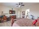 A spacious main bedroom with a decorative ceiling fan, desk, and connecting bath at 7264 Summer Duck Way, North Las Vegas, NV 89084