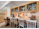 View of breakfast bar with seating, cabinets, glass storage and appliances at 775 Cathy Ln, Henderson, NV 89015