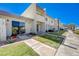 Inviting townhouse exterior showcasing well-maintained landscaping, including green lawns and decorative plantings at 775 Cathy Ln, Henderson, NV 89015