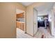 Hallway leading to the living room and kitchen with neutral paint and tile floors at 775 Cathy Ln, Henderson, NV 89015