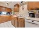 Well-maintained kitchen with white appliances, oak cabinets, and durable countertops at 775 Cathy Ln, Henderson, NV 89015